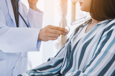 Midsection of woman standing in corridor