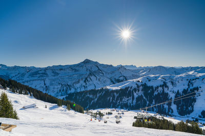 Scenic view of snowcapped mountains against clear sky