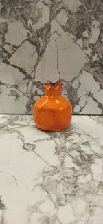 Close-up of orange pumpkin on table against wall during winter