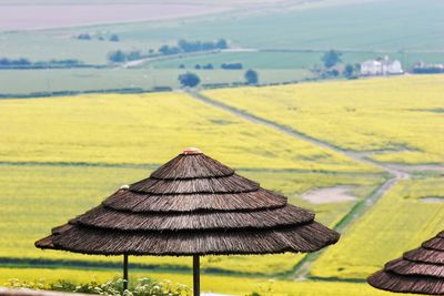 Thatched roof parasol against landscape