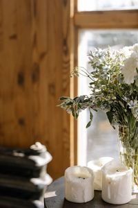 Close-up of white flower vase on table at home