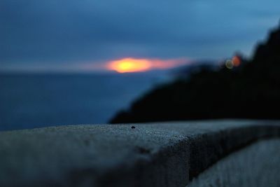 Close-up of sea against sky at sunset