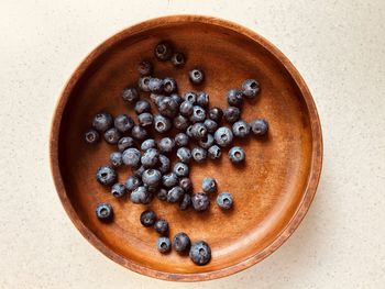  blueberries, scatter pattern, wooden bowl. fresh, colourful, juicy, sweet, nutritious, summer fruit.