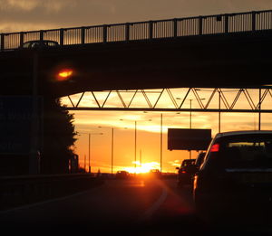 Bridge over river at sunset