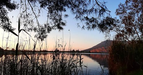 Scenic view of lake against sky during sunset