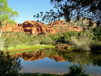 Reflection of red rock in water