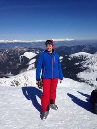 Portrait of a young woman standing on mountain