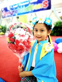 Portrait of cute girl holding balloons