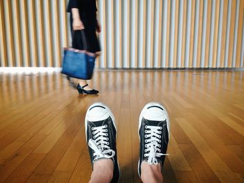 Low section of woman standing on tiled floor