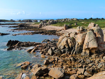 Rocks on beach against sky