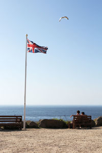 Lifeguard hut on beach against clear sky