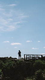 Man standing on field against sky