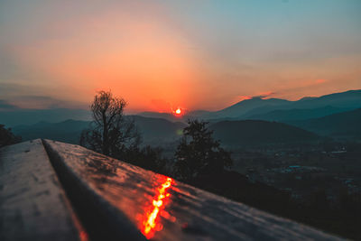 Scenic view of mountains against romantic sky at sunset