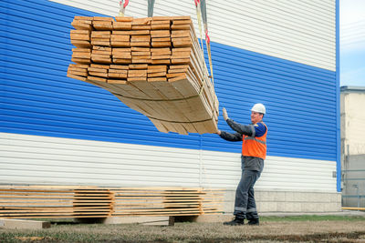 Full length of man standing against wall