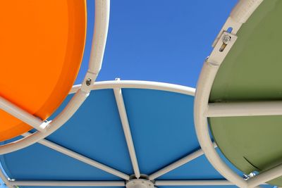 Low angle view of airplane against clear blue sky