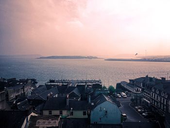 High angle view of buildings by sea against sky