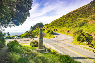 High angle view of road amidst trees against sky