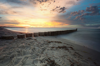 Scenic view of beach against sky during sunset