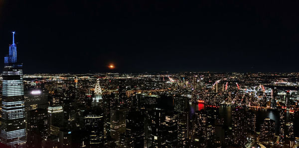 High angle view of illuminated city buildings at night