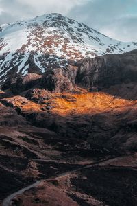 Scenic view of snowcapped mountains against sky during winter