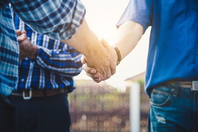 Midsection of man holding hands