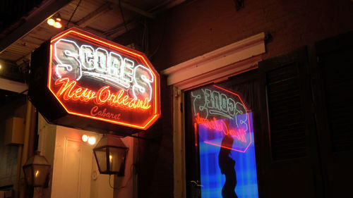 Low angle view of illuminated neon sign at night