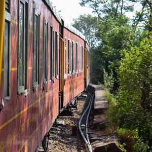 Kalka shimla toy train moving on mountain slopes, beautiful view, one side mountain, one side valley