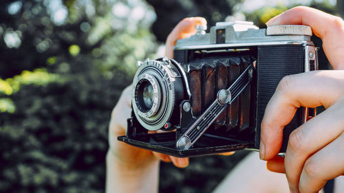 Close-up of person holding camera