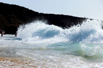 View of waves in sea against clear sky