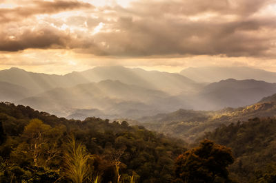 Scenic view of mountains against cloudy sky
