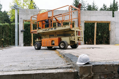 Scissor lift platform on a construction site. building concreate house with mobile transportation