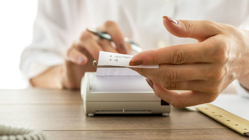 Close-up of woman hand on table