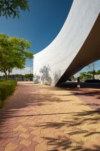 Footpath leading towards building against sky