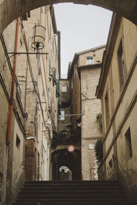 Low angle view of staircase amidst buildings in city