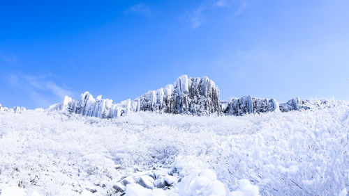 Low angle view of snow on mountain against sky