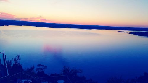 Reflection of trees on water against sky