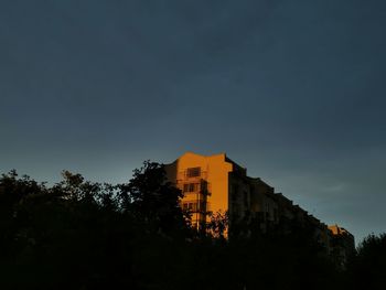 Low angle view of buildings against sky at sunset