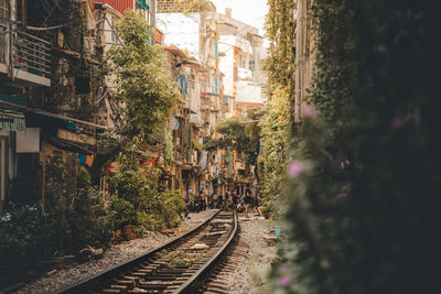 Railroad tracks amidst buildings in city