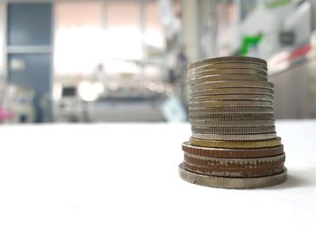 Close-up of coin stack on table