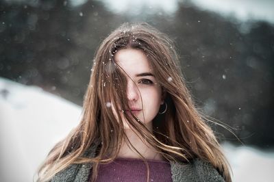 Close-up portrait of a serious young woman in winter