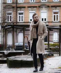 Full length portrait of woman standing in snow