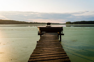 Pier over lake against sky