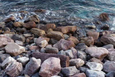 High angle view of pebbles on beach