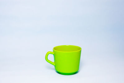 Close-up of coffee cup on table against white background