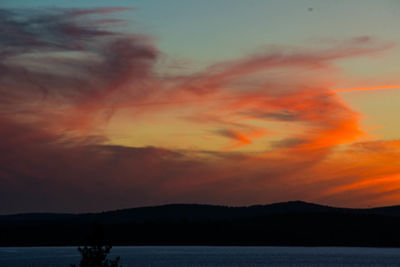 Scenic view of lake against orange sky