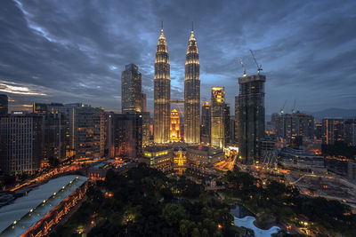 Illuminated cityscape against sky at night