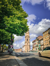 Street amidst buildings in city against sky