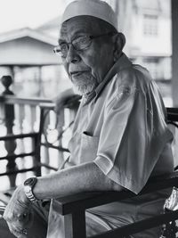 Close-up of senior man sitting on chair