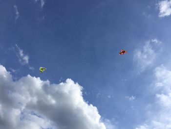 Low angle view of parachute flying in sky