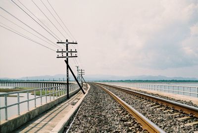 Railroad track against sky during sunset